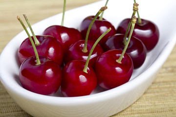 Close up cherries in white bowl
