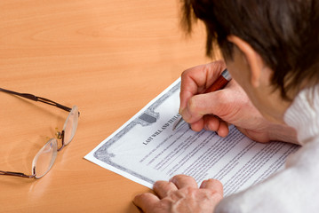 mature woman signing Last Will