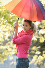 attractive girl with colorful umbrella on natural background
