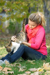 attractive young girl with cat outdoors