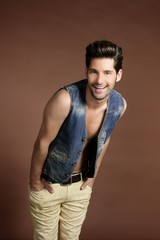 Handsome sexy young man portrait denim vest