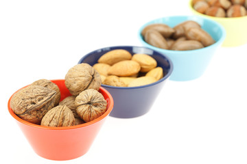 nuts in bowls isolated on white