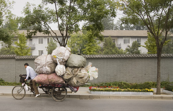 Fototapeta Chinese man on overloaded bike