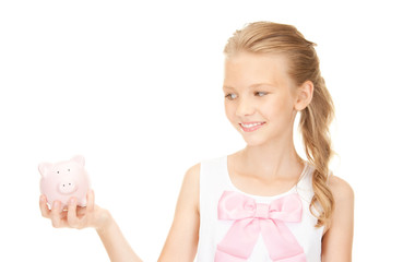 lovely teenage girl with piggy bank