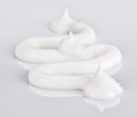 Light face cream samples on white