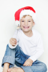 happy santa boy with sparkler over white