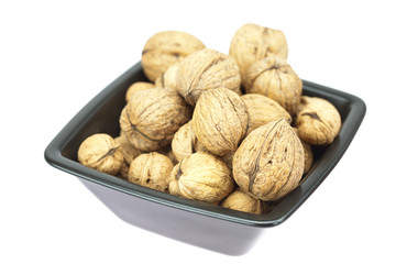 walnuts in a bowl isolated on white