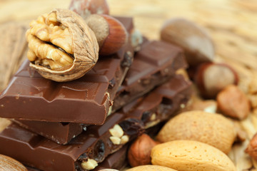 bar of chocolate and nuts on a wicker mat