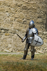 Medieval european knight near citadel wall
