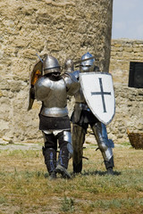 Medieval european knight near citadel wall