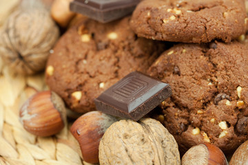 oatmeal cookies, chocolate and nuts on a wicker mat