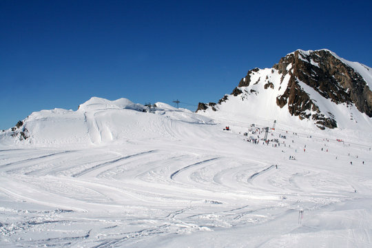 Skiers and lift on mountainside