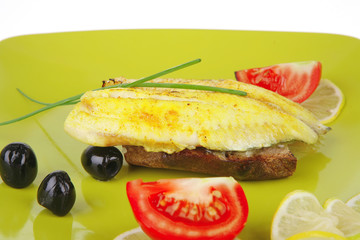fish fillet served with greek olives