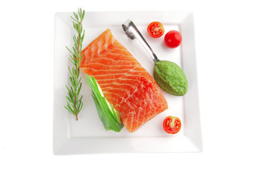 smoked salmon fillet and tomatoes with pesto sauce