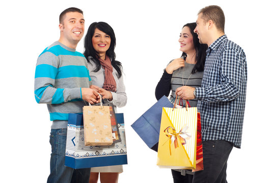 Two couples with shoppings bags