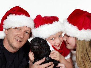 Happy family with dog having fun on St. Nicholas´Day