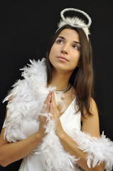 Praying pretty angel with the palms joined together