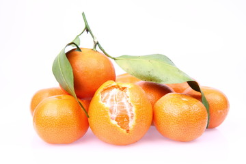 Mandarin oranges one partially peeled, on white background