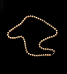 White pearls on black background