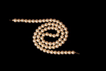 White pearls on black background