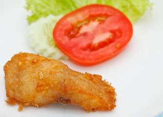 Piece of fried fish and vegetables