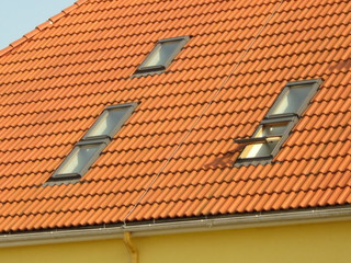 Fototapeta premium Red tile roof and skylights