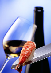 glass of white wine with bottle and a piece of salmon
