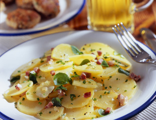 bacon and potato omelette on a white plate and a fork