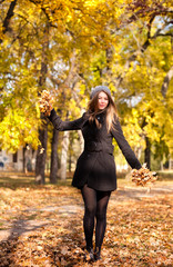 beautiful young woman in the park autumn vibrant colors