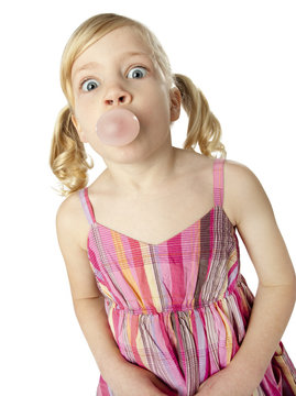 Young girl blowing bubble with gum
