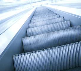 gray steps of escalator in business center
