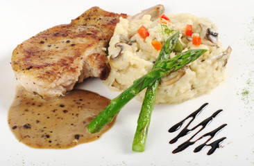 Risotto, green asparagus and meat with gravy