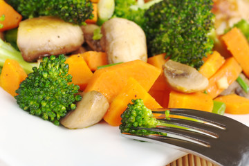 Fried vegetables with fork