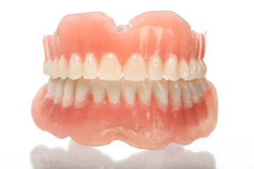 full set of acrylic denture isolated on white background