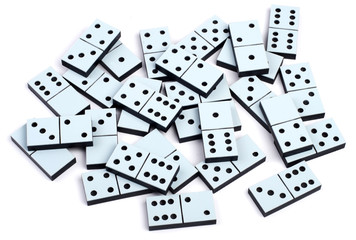 Domino pieces laying on white background randomly