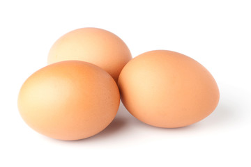 Three brown eggs on white background