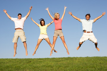 Fototapeta na wymiar Young couples jumping in air