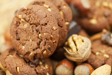 oatmeal cookies, chocolate and nuts on a wicker mat