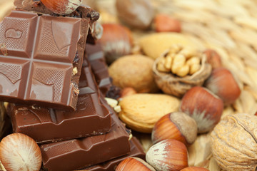 bar of chocolate and nuts on a wicker mat