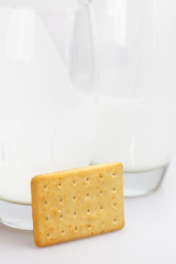 two glasses of milk and cookies on a gray background