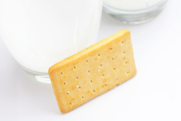 two glasses of milk and cookies on a gray background