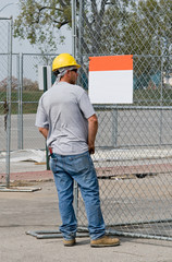 Worker Looking at Blank Sign