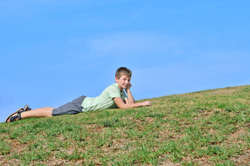 Naklejka na ściany i meble The boy on the grass
