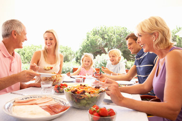 Extended family, parents, grandparents and children, eating outd