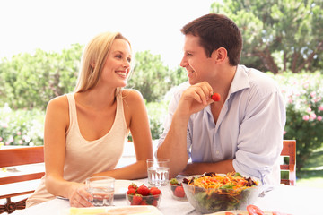 Young couple eating outdoors