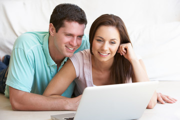 Fototapeta premium Young couple on laptop computer