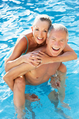 Senior couple having fun in pool