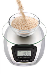 Digital kitchen scale with bowl of oat bran