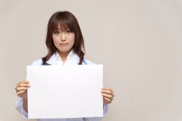 Fototapeta premium a portrait of young doctor taking a blank whiteboard