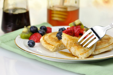 pancake with maple syrup,honey and berries